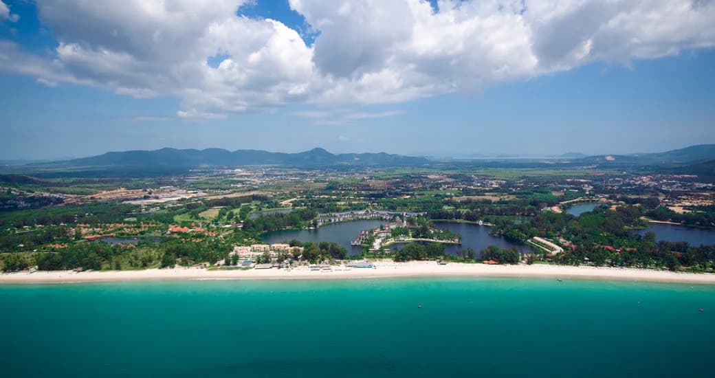 Bang Tao Beach and Laguna Phuket seen from the sea, the hills behind